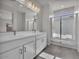 Modern bathroom featuring double sinks, a sleek mirror, and a glass-enclosed shower at 2512 N Pony Ln, Casa Grande, AZ 85122