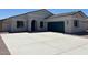 Charming single-story home with a dark-green garage door and a spacious driveway at 2512 N Pony Ln, Casa Grande, AZ 85122