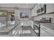 Modern kitchen featuring white cabinets, granite counters, and stainless steel appliances at 2512 N Pony Ln, Casa Grande, AZ 85122