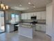 Modern kitchen featuring white cabinets, stainless steel appliances, and a central island at 2512 N Pony Ln, Casa Grande, AZ 85122