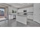 Bright kitchen area featuring white cabinets, a center island, granite countertops, and backyard access at 2512 N Pony Ln, Casa Grande, AZ 85122