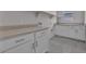 Bright laundry room with ample counter space and built-in cabinets at 2512 N Pony Ln, Casa Grande, AZ 85122