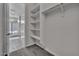 Walk-in closet featuring built-in shelving and hanging rods at 2512 N Pony Ln, Casa Grande, AZ 85122