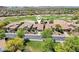 Aerial view of home in golf course community with lush green fairways and mountain views at 27320 N 127Th Dr, Peoria, AZ 85383