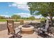 Cozy fire pit area with golf course views and plenty of seating at 27320 N 127Th Dr, Peoria, AZ 85383