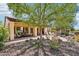 Spacious backyard with a covered patio, outdoor kitchen, fire pit, and beautiful desert landscaping at 27320 N 127Th Dr, Peoria, AZ 85383