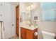 Bathroom featuring modern fixtures, a vanity, a toilet, and a mirror at 27320 N 127Th Dr, Peoria, AZ 85383