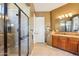 Well lit bathroom featuring a spacious shower, neutral toned walls, and large vanity with sink at 27320 N 127Th Dr, Peoria, AZ 85383