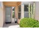 Close up of front door featuring manicured landscaping and decorative potted plant at 27320 N 127Th Dr, Peoria, AZ 85383