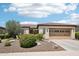 Charming single-story home with desert landscaping, a tile roof and a two-car garage at 27320 N 127Th Dr, Peoria, AZ 85383