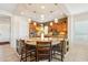 A kitchen island offers bar stool seating and pendant lights hanging from the recessed ceiling at 27320 N 127Th Dr, Peoria, AZ 85383