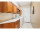 Functional laundry room with sink, storage, and modern appliances at 27320 N 127Th Dr, Peoria, AZ 85383
