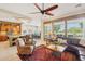 Open-concept living room showcasing kitchen, dining, and golf course views through large windows at 27320 N 127Th Dr, Peoria, AZ 85383