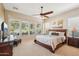 The main bedroom features a ceiling fan and large windows that let in natural light at 27320 N 127Th Dr, Peoria, AZ 85383