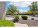 Street view showcasing the well-maintained landscaping and green spaces in the neighborhood at 27320 N 127Th Dr, Peoria, AZ 85383