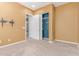 A carpeted bedroom has a closet and an open doorway, neutral walls and white trim at 27537 W Yukon Dr, Buckeye, AZ 85396