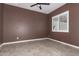 Cozy bedroom with a ceiling fan and window with plantation shutters at 27537 W Yukon Dr, Buckeye, AZ 85396