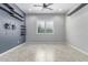 Modern bedroom with decorative shelving, neutral walls, and tiled flooring at 27537 W Yukon Dr, Buckeye, AZ 85396