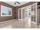 Bedroom featuring natural lighting, double glass doors, and tiled flooring at 27537 W Yukon Dr, Buckeye, AZ 85396