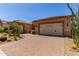 Inviting home with desert landscaping, paver driveway, and a two-car garage, creating great curb appeal at 27537 W Yukon Dr, Buckeye, AZ 85396