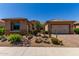 Charming home with a well-manicured desert landscaped front yard and an attached two-car garage at 27537 W Yukon Dr, Buckeye, AZ 85396