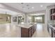 Spacious open kitchen with stone countertops, stainless appliances, and pendant lighting overlooking the living spaces at 27537 W Yukon Dr, Buckeye, AZ 85396
