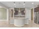 Bright kitchen with granite island, stainless appliances, pendant lights and dark wood cabinets, ideal for cooking at 27537 W Yukon Dr, Buckeye, AZ 85396