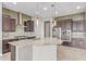 Gourmet kitchen features a large island with granite countertops, stainless steel appliances, and stylish pendant lighting at 27537 W Yukon Dr, Buckeye, AZ 85396