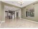 Open dining area leading to kitchen with stainless appliances, island, and tile floors at 27537 W Yukon Dr, Buckeye, AZ 85396