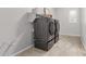 This laundry room has modern appliances, tile floors, and shelving at 27537 W Yukon Dr, Buckeye, AZ 85396