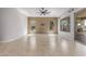 Spacious living room with tile flooring, large windows for natural light, and a ceiling fan for added comfort at 27537 W Yukon Dr, Buckeye, AZ 85396
