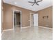 View of a neutral main bedroom showing open doors to a walk-in closet and bathroom at 27537 W Yukon Dr, Buckeye, AZ 85396