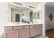Bathroom featuring a double sink vanity, large mirror, and stylish decor at 280 W Sheffield Ave, Gilbert, AZ 85233