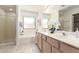 Bright bathroom featuring double sinks, bathtub, and glass-enclosed shower at 280 W Sheffield Ave, Gilbert, AZ 85233