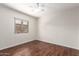 Simple, empty bedroom features hardwood flooring, a bright window, and ample natural light at 280 W Sheffield Ave, Gilbert, AZ 85233