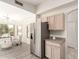 Well-lit kitchen area with stainless steel fridge, eat in nook and adjacent seating area at 280 W Sheffield Ave, Gilbert, AZ 85233