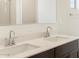 Modern bathroom featuring a double sink vanity with white countertop and sleek chrome fixtures at 37139 W Prado St, Maricopa, AZ 85138