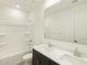 Well-lit bathroom showcasing double sinks, modern fixtures, and a shower-tub combo at 37139 W Prado St, Maricopa, AZ 85138