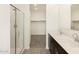 Bathroom with double vanity, glass shower, and walk-in closet at 37139 W Prado St, Maricopa, AZ 85138