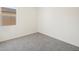 Bright bedroom featuring gray carpeting and a large window at 37139 W Prado St, Maricopa, AZ 85138