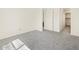 A bright bedroom with neutral carpet and a view to the hall at 37139 W Prado St, Maricopa, AZ 85138