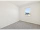 Neutral bedroom featuring a window and neutral carpeting at 37139 W Prado St, Maricopa, AZ 85138