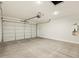 Spacious garage with a large roll-up door and water heater at 37139 W Prado St, Maricopa, AZ 85138