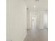 Inviting hallway featuring neutral tile flooring and bright, neutral paint throughout at 37139 W Prado St, Maricopa, AZ 85138