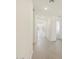 Inviting hallway featuring neutral tile flooring and bright, neutral paint throughout at 37139 W Prado St, Maricopa, AZ 85138