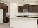 Kitchen featuring granite counters, dark wood cabinets and stainless steel appliances at 37139 W Prado St, Maricopa, AZ 85138