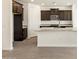 Kitchen with dark cabinets, granite counters and stainless appliances at 37139 W Prado St, Maricopa, AZ 85138