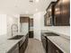 Spacious kitchen featuring stainless appliances, dark cabinets, and stone countertops at 37139 W Prado St, Maricopa, AZ 85138