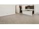 Spacious open-concept living area leading into the kitchen with wood look floors at 37139 W Prado St, Maricopa, AZ 85138