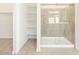 Well-organized bathroom area with open shelving and a modern glass-enclosed shower at 37154 W La Paz St, Maricopa, AZ 85138